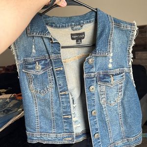 Sleeveless distressed denim jacket